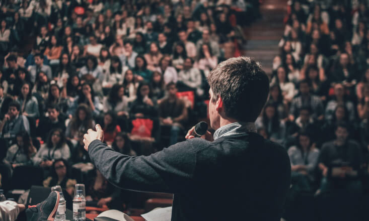 Person speaking in front of the crowd