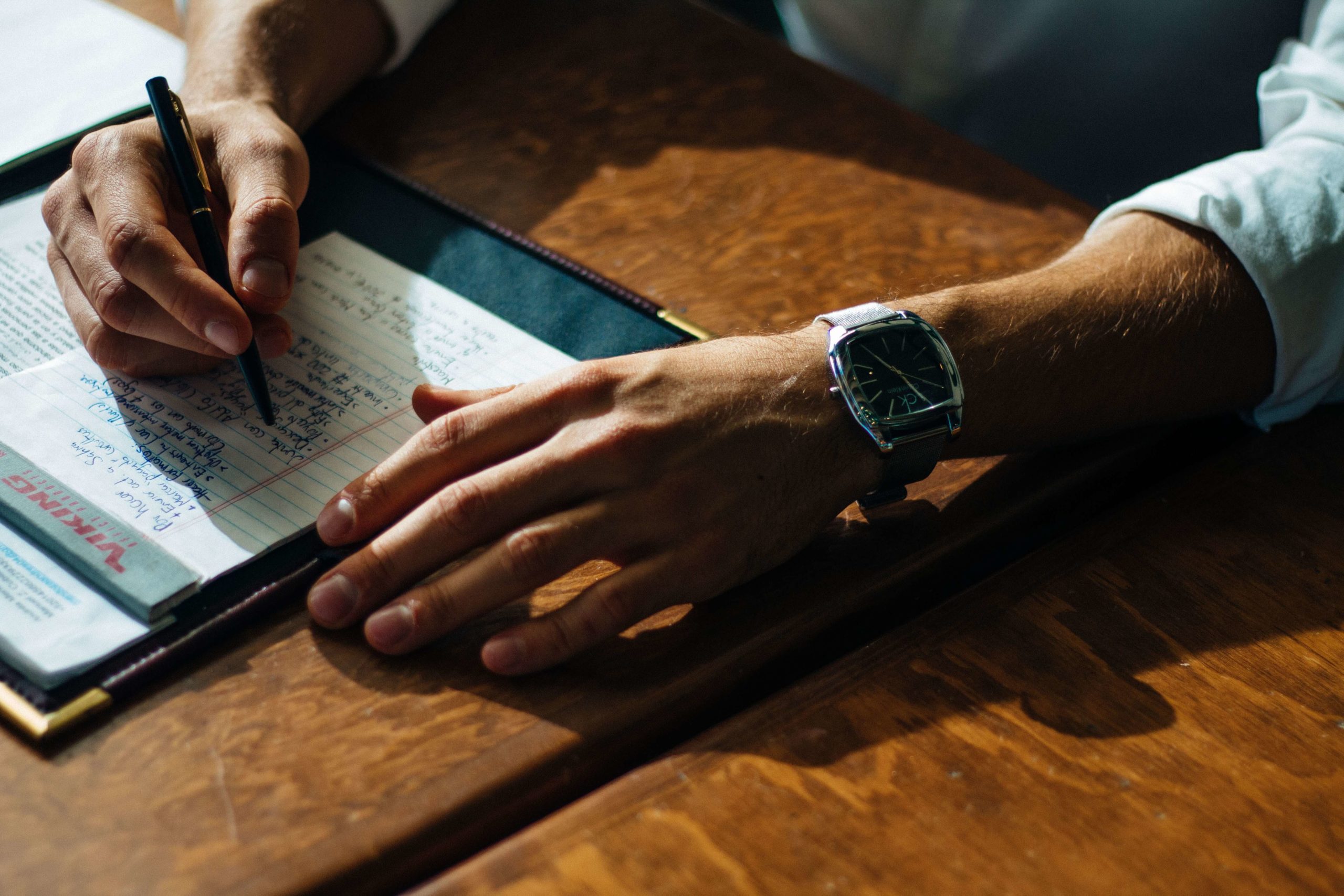 Sales script. Businessman writing on a piece of paper